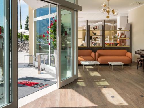 a living room with a couch and a table at Hotel Leonardo Da Vinci in Limone sul Garda