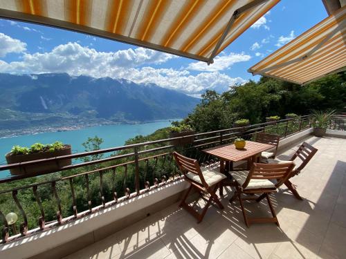a balcony with a table and chairs and a view at Casa Nonno Sergio lake view by Gardadomusmea in Tremosine Sul Garda