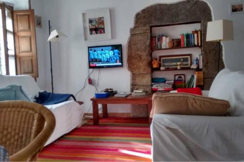 a living room with a couch and a table at Pexe na mar in Lastres