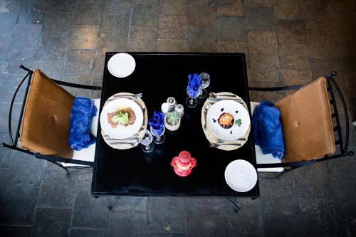 an overhead view of a table with plates of food at Olive Grove Guesthouse in Windhoek