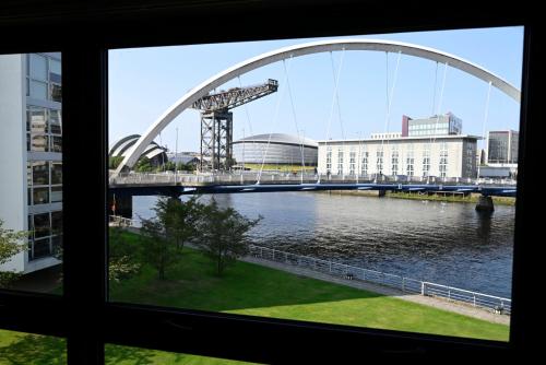 a view from a window of a bridge over a river at ArcView - SEC Hydro Two Bed Flat With Free parking and Great View in Glasgow