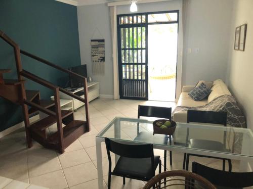 a living room with a glass table and a couch at Casa Ampla a 300 metros de uma das melhores praia de SSA in Salvador