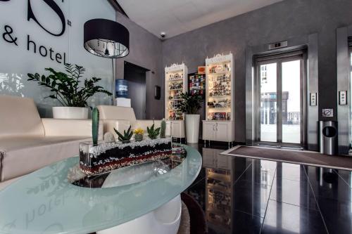 a living room with a cake on a glass table at Rius Hotel Lviv in Lviv