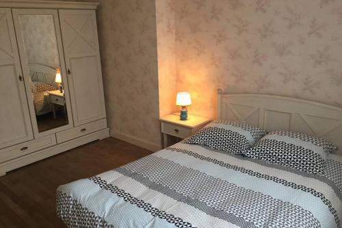 a bedroom with a bed and a dresser and a mirror at Escapade en Périgord in Villefranche-du-Périgord