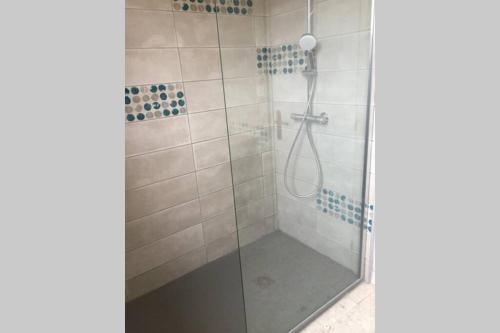 a bathroom with a shower with a glass door at Escapade en Périgord in Villefranche-du-Périgord