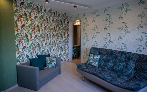 a living room with a couch and a wall mural at Nameja Apartments in Jēkabpils