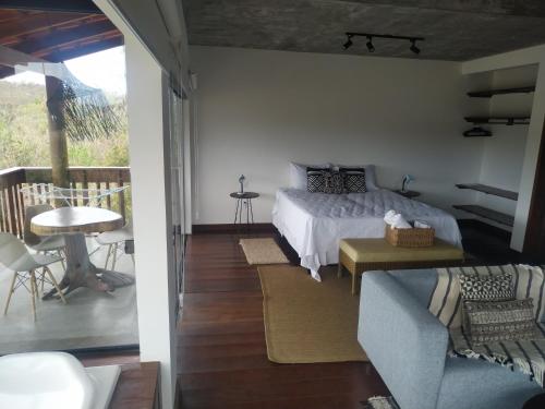 a bedroom with a bed and a balcony at Pousada Caminho Das Cachoeiras in Sao Jorge