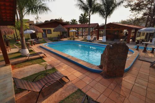a swimming pool with a slide in a resort at Pousada Pé da Serra in Lindóia