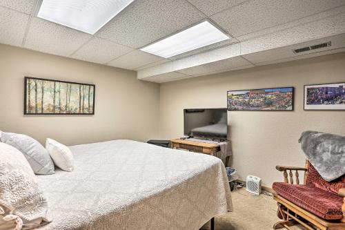 a bedroom with a bed and a flat screen tv at Walk to Main St Sturgis Apt with Grill! in Sturgis