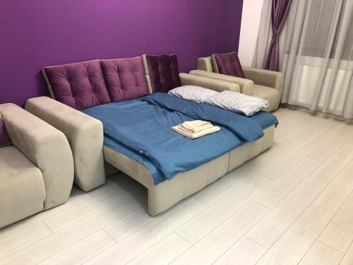 a couch and a bed with a blanket on it at Apartament - Drumul Taberei Parc Residence in Bucharest