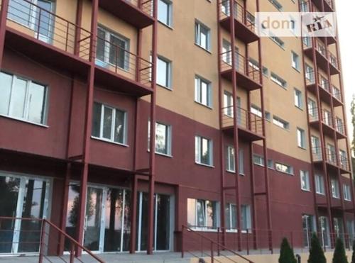 a red building with balconies on the side of it at Квартира студия in Izmail