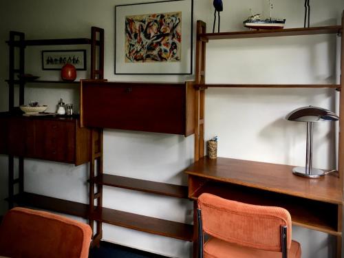 a room with a desk and a table and chairs at Pension Homeland in Amsterdam