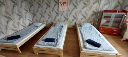 three bunk beds in a room with a wall at Nad Morzem in Gdańsk