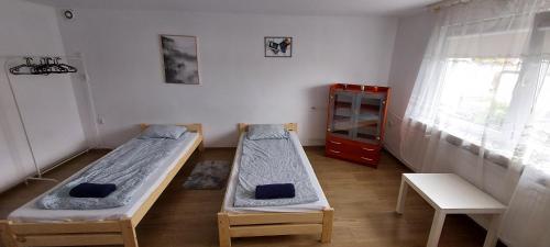 a room with two beds and a red cabinet at Nad Morzem in Gdańsk