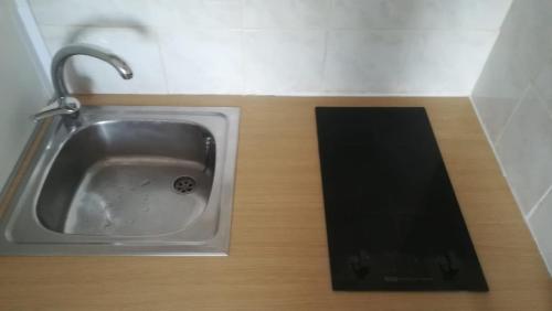 a kitchen sink with a tablet sitting next to it at Empuriabrava Vue Mer in Empuriabrava