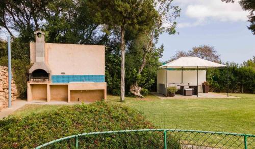 a building with a gazebo in a park at Villa Coqueta in Sant Josep