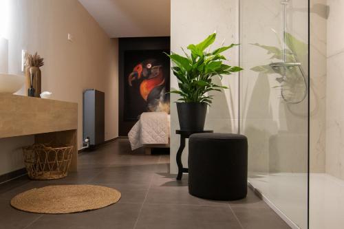 a living room with a plant sitting on a table at Boulevard Botanie city apartment with parking in Hasselt