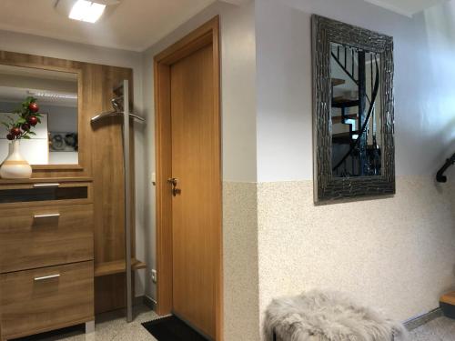 a bathroom with a door and a mirror on the wall at Ferienwohnungen Margot in Iserlohn