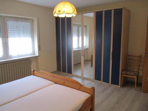 1 dormitorio con cama y espejo grande en Ferienhaus Raue, en Sulzbach