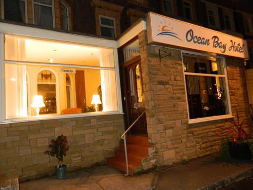 a store front of an ocean bay hotel at night at Ocean Bay in Blackpool