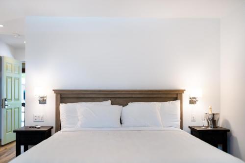 a bedroom with a large white bed with two night stands at The Inn on Pine in Calistoga