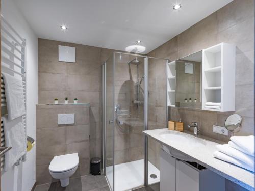 a bathroom with a shower and a toilet and a sink at Apartment Steixner in Westendorf