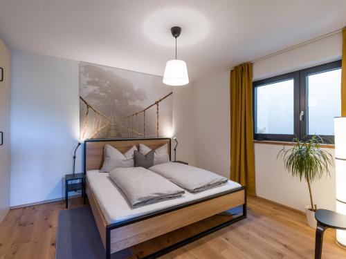a bedroom with a bed and a large window at Apartment Steixner in Westendorf