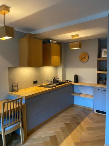 a kitchen with blue cabinets and a counter top at Apartament Krakowska in Bochnia