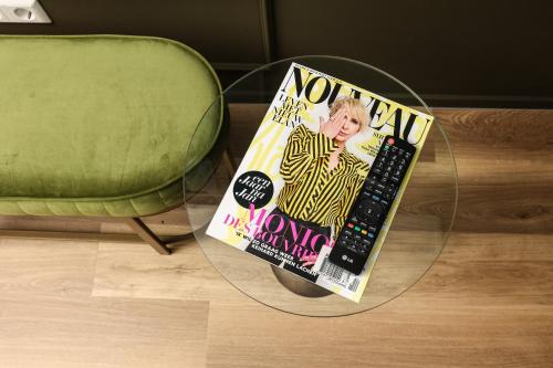 a magazine sitting on top of a glass table at Heeren aan de Haven in Streefkerk