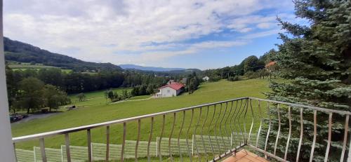 a view from the balcony of a house in a green field at Baranie Wzgórze Ustroń Basen Sauna Plac Zabaw in Cisownica