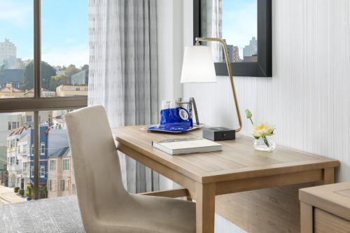 a room with a desk with a lamp and a chair at Hotel Caza Fisherman's Wharf in San Francisco
