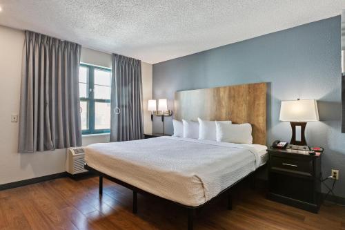 a hotel room with a large bed and a window at Extended Stay America Suites - Boston - Burlington in Burlington
