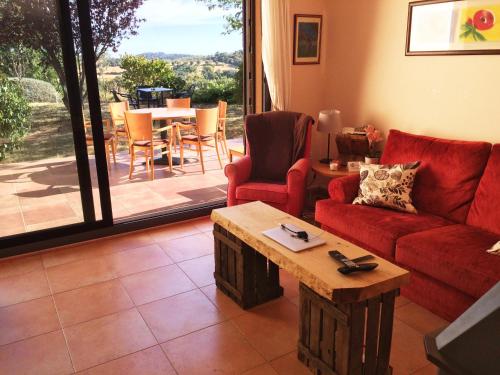 a living room with a red couch and a table at Hotel Era Conte in Bierge