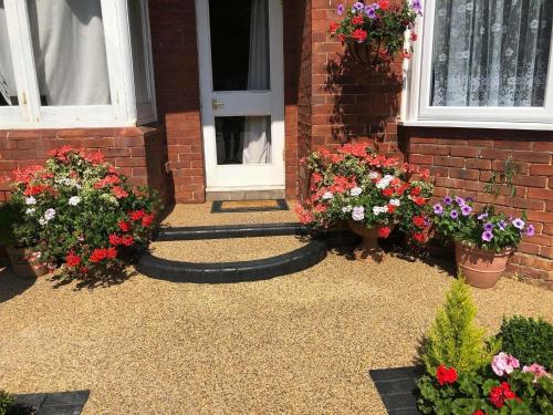 a house with flowers in front of a door at ElMurrs in Bournemouth