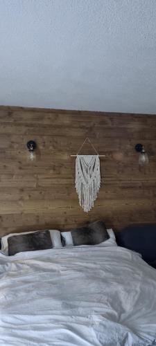 a bedroom with a bed with a wooden head board at Luxury Central Apartment MONTCHAVIN in Bellentre