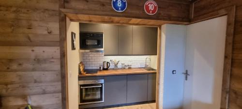 a kitchen with a sink and a stove at Luxury Central Apartment MONTCHAVIN in Bellentre