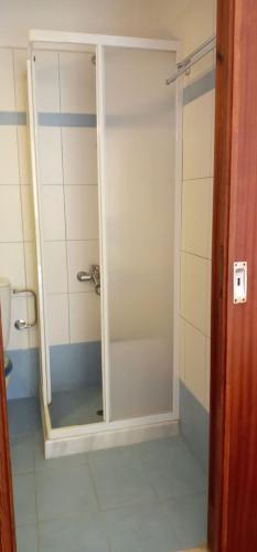a bathroom with a shower with a glass door at FAROS in Agios Nikolaos