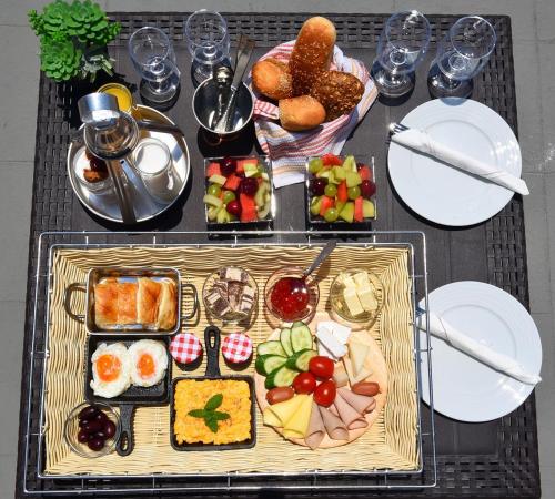 a table with a tray of food on a table at Villa Mare Angelica in Perivolos