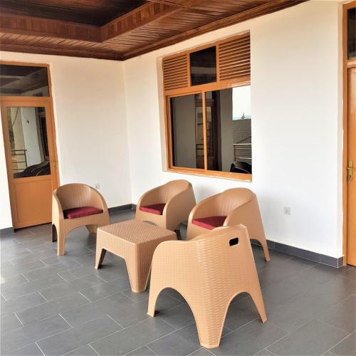 a waiting room with chairs and a table at Isaro House Kigali in Kigali