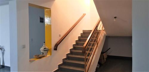 a staircase in a house with a stair case at Isaro House Kigali in Kigali