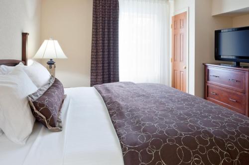 a bedroom with a bed and a flat screen tv at Staybridge Suites - Philadelphia Valley Forge 422 by IHG in Royersford