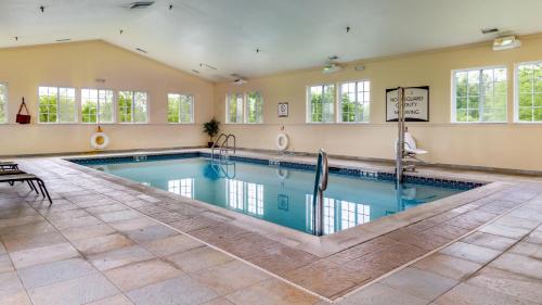 a large swimming pool in a large room with windows at Staybridge Suites - Philadelphia Valley Forge 422, an IHG Hotel in Royersford