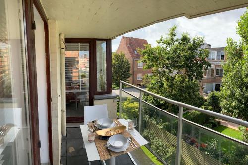 a balcony with a table with food on it at TOP appartement met garage "Au Franelle" in Ostend