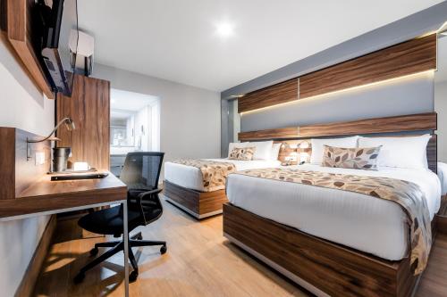a hotel room with a bed and a desk at Sleep Inn Monterrey Norte in Monterrey