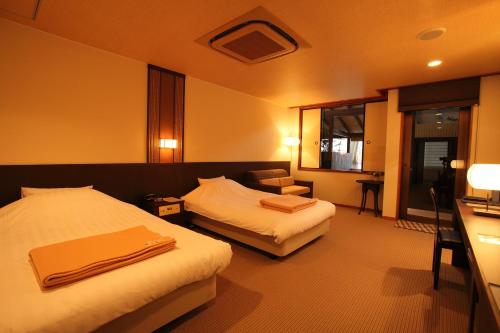 Ένα ή περισσότερα κρεβάτια σε δωμάτιο στο Hotel Yumeshizuku