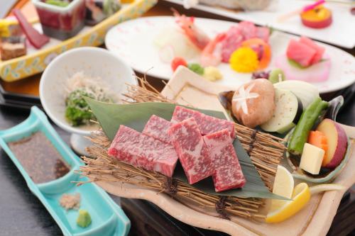 a tray of different types of food on a table at Hotel Yumeshizuku in Minami Aso