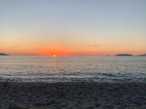 a sunset over a body of water with a beach at BedRoom Spiaggia di Ponente in Milazzo