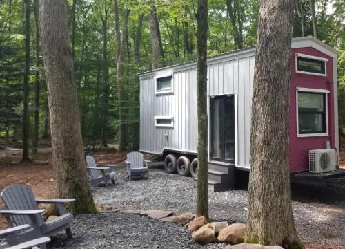 a tiny house in the woods between two trees at Camptel Poconos in Albrightsville
