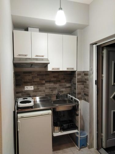 Kuchyň nebo kuchyňský kout v ubytování Miltos rooms