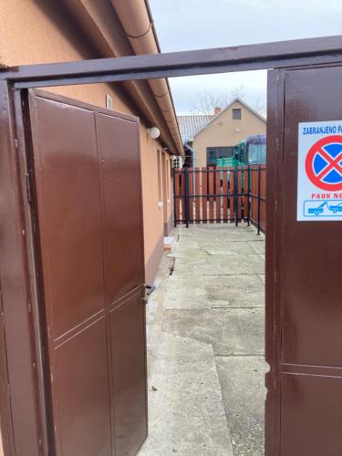an open door to a building with a sign on it at House Apartment in Pančevo